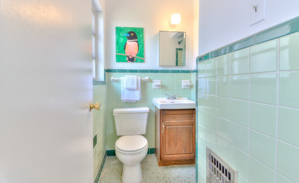Small midcentury master bathroom in Tampa with raised-panel cabinets, dark wood cabinets, a two-piece toilet, ceramic tile, white walls, mosaic tile floors, a console sink and green floor.