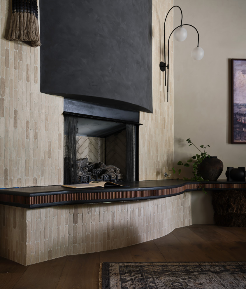 Barrel & Beam - ighting the room’s height and drawing the eye upward.
The fireplace, which previously faded into the background, is now a bold statement piece. With a custom surround and built-in seating for family functions and entertaining, it serves as a dramatic focal point in the room, offering both style and function.