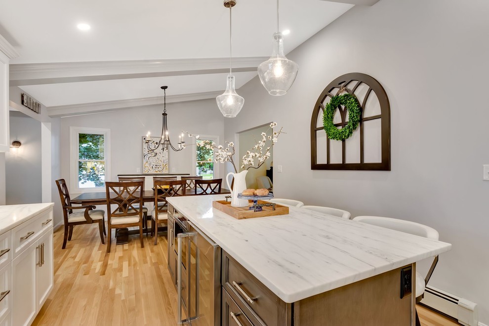 Transitional light wood floor eat-in kitchen photo in Boston with an island