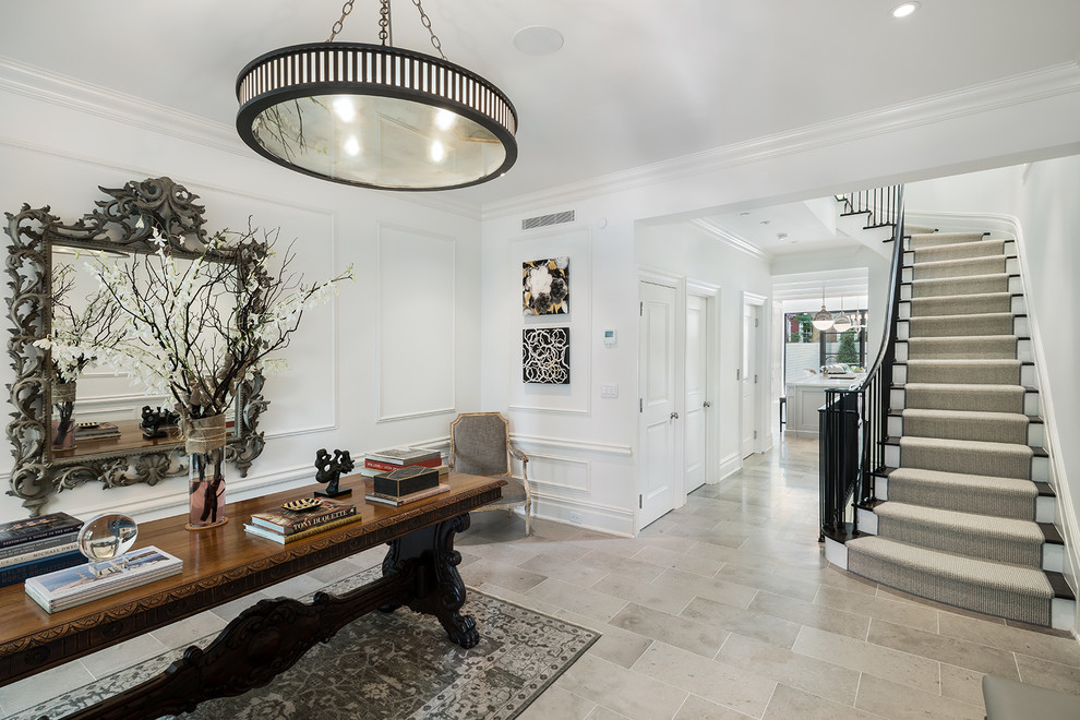 Photo of a traditional foyer in New York with white walls and grey floor.