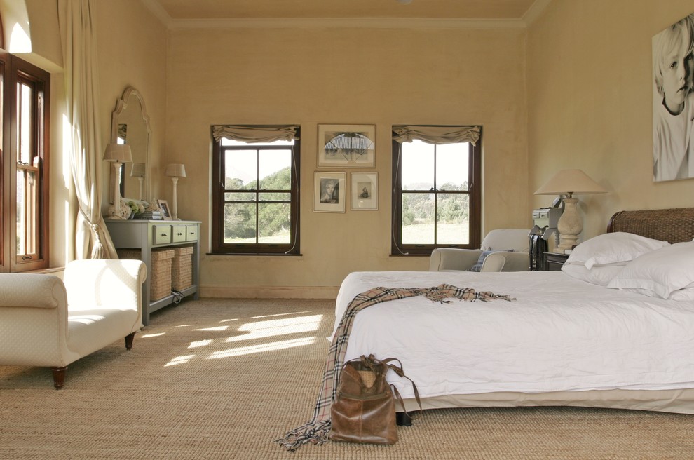 Inspiration for a country bedroom in Amsterdam with beige walls and carpet.