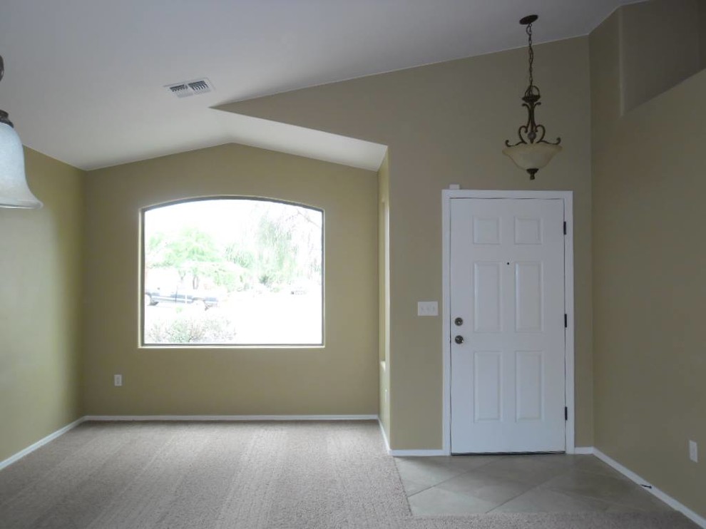 Entryway photo in Phoenix with beige walls and a white front door