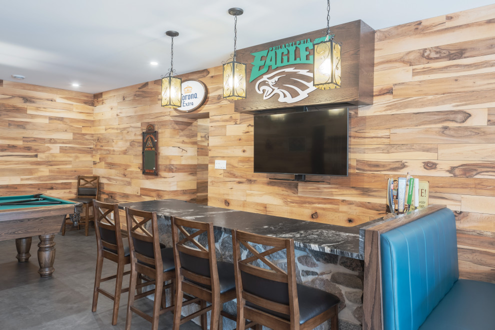 Basement - large rustic walk-out vinyl floor, gray floor, exposed beam and wood wall basement idea with a bar, multicolored walls, a standard fireplace and a stone fireplace