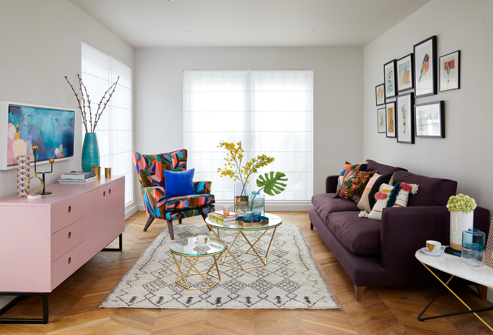 Inspiration for a mid-sized eclectic open concept living room in London with white walls, medium hardwood floors, no fireplace, no tv and brown floor.