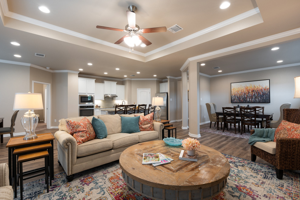Photo of an arts and crafts open concept family room in Austin with beige walls, vinyl floors, brown floor and recessed.