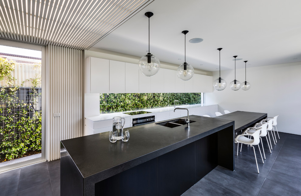 Photo of a contemporary kitchen in Sydney with an undermount sink, flat-panel cabinets, white cabinets, wood benchtops and with island.