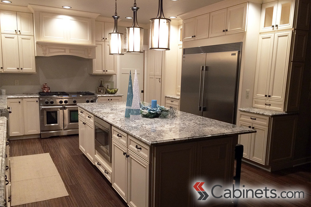 This is an example of a large transitional u-shaped kitchen in Tampa with recessed-panel cabinets, white cabinets, stainless steel appliances and with island.