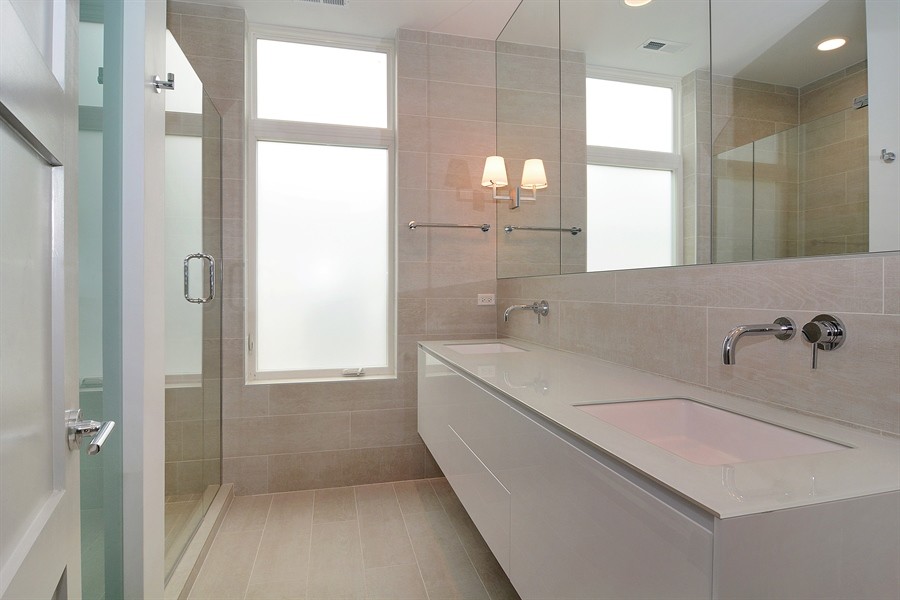 Design ideas for a small contemporary master bathroom in Chicago with an undermount sink, flat-panel cabinets, white cabinets, glass benchtops, an alcove shower, black tile, porcelain tile, porcelain floors and beige walls.