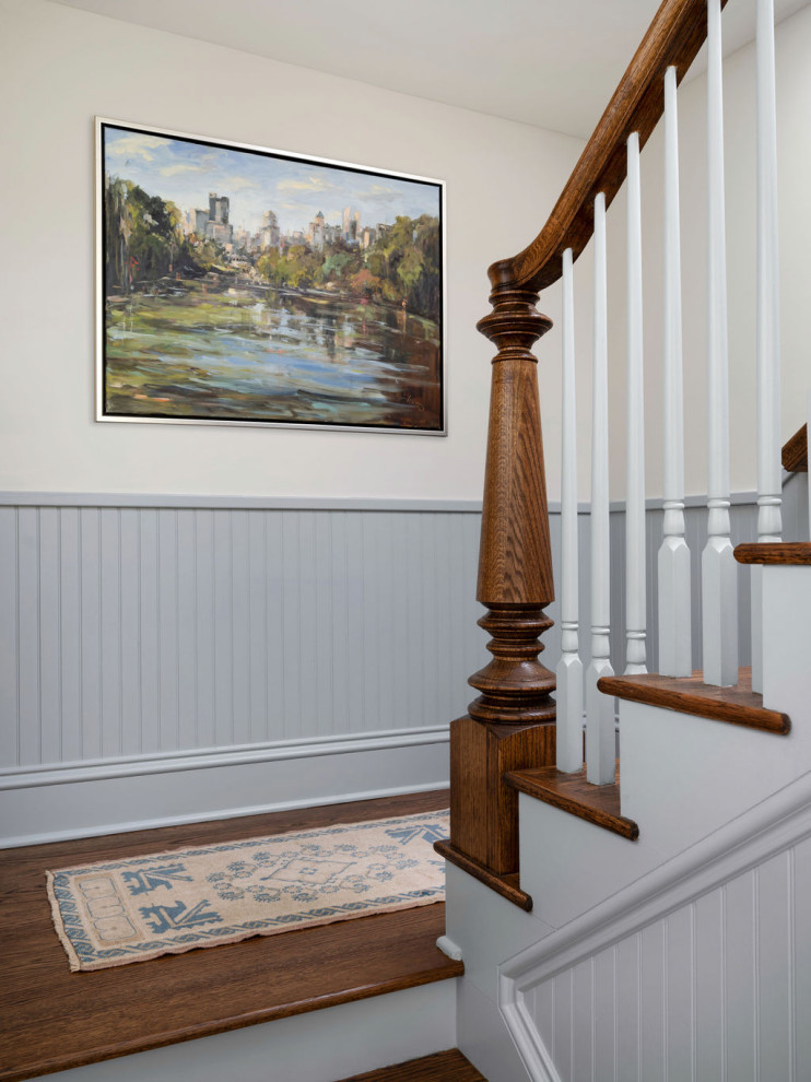 Staircase - traditional wooden wood railing and wainscoting staircase idea in Atlanta