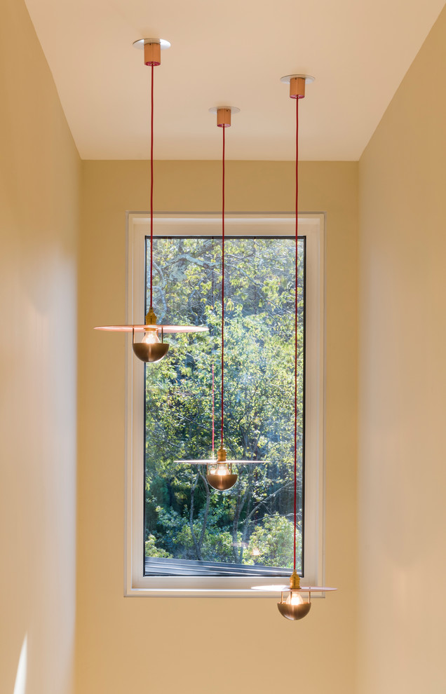 Example of a mid-sized transitional light wood floor and beige floor foyer design in Providence with white walls and a red front door