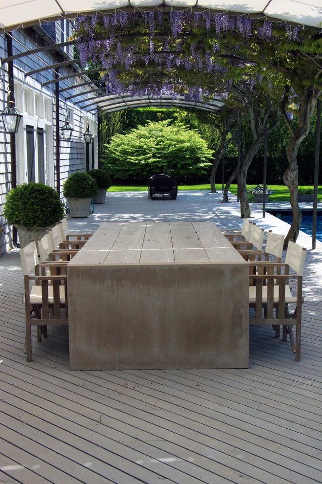 This is an example of a traditional backyard deck in New York with a pergola.