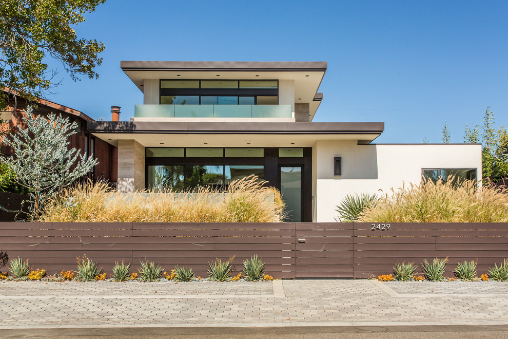 This is an example of a contemporary two-storey white exterior in San Diego with a flat roof.