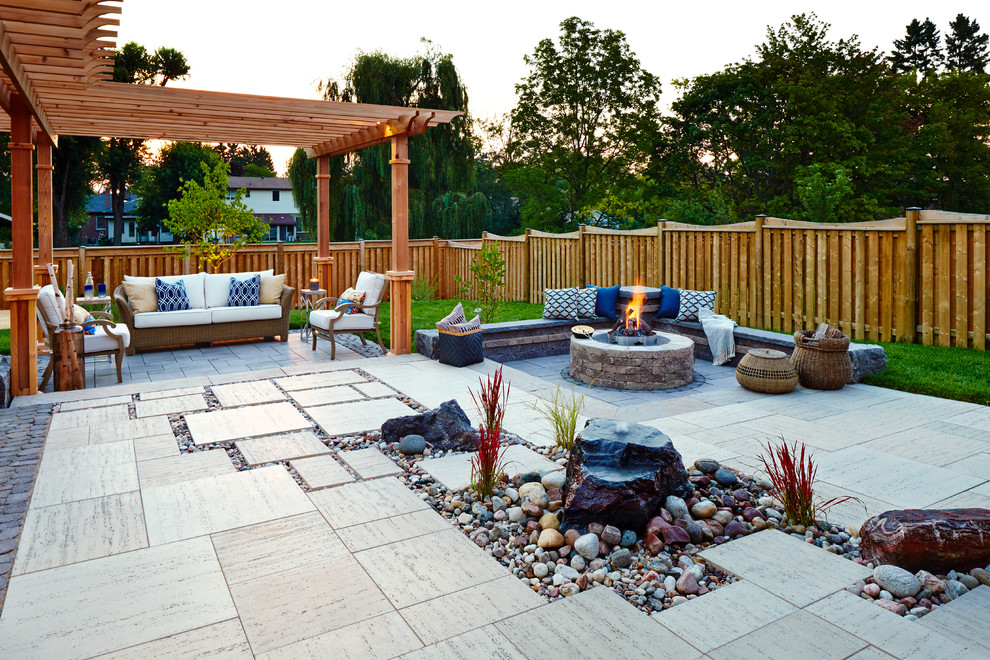 Inspiration for a mid-sized contemporary backyard patio in Toronto with a fire feature, concrete slab and a gazebo/cabana.
