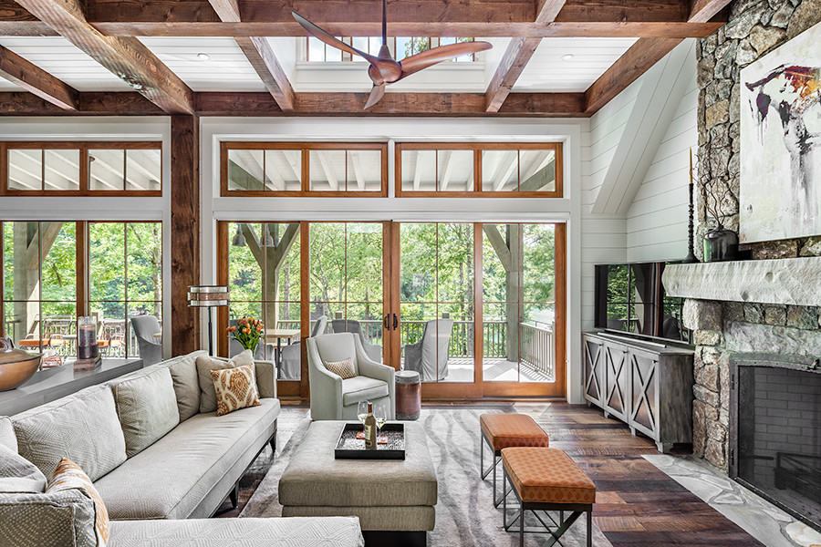 Large modern sunroom in Other with dark hardwood floors, a standard fireplace, a stone fireplace surround and a standard ceiling.