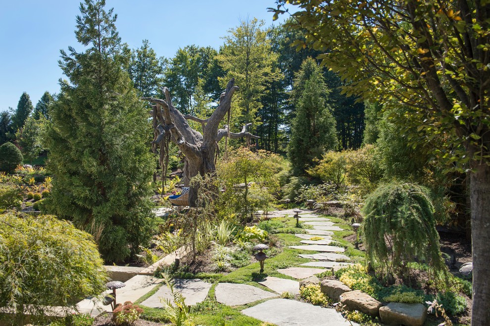 Traditional full sun garden in Cleveland with a garden path and natural stone pavers.