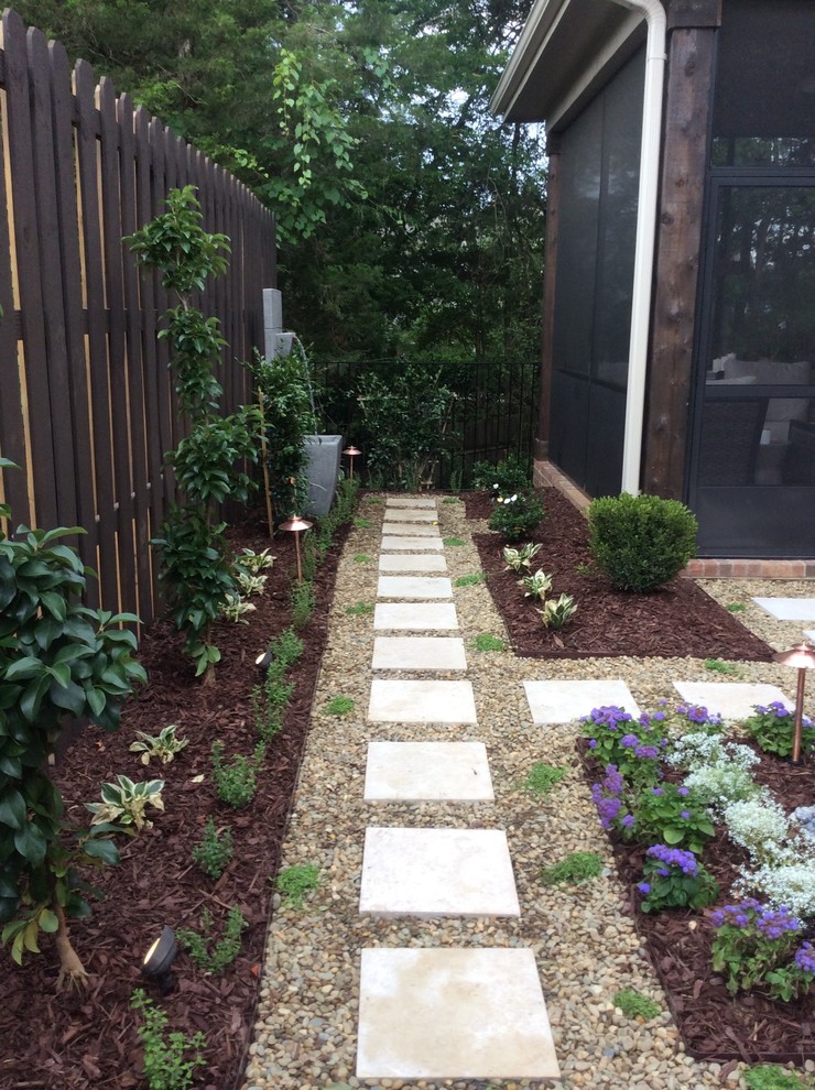 Small traditional courtyard partial sun formal garden in Charlotte with a garden path and concrete pavers for summer.
