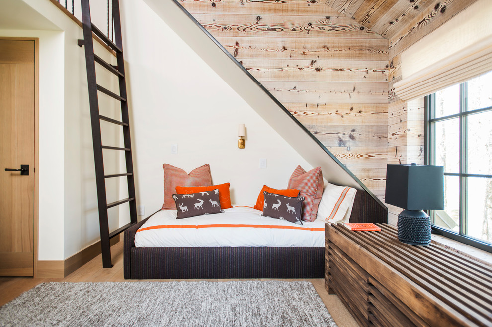 This is an example of a country kids' bedroom in Denver with white walls, medium hardwood floors and brown floor.