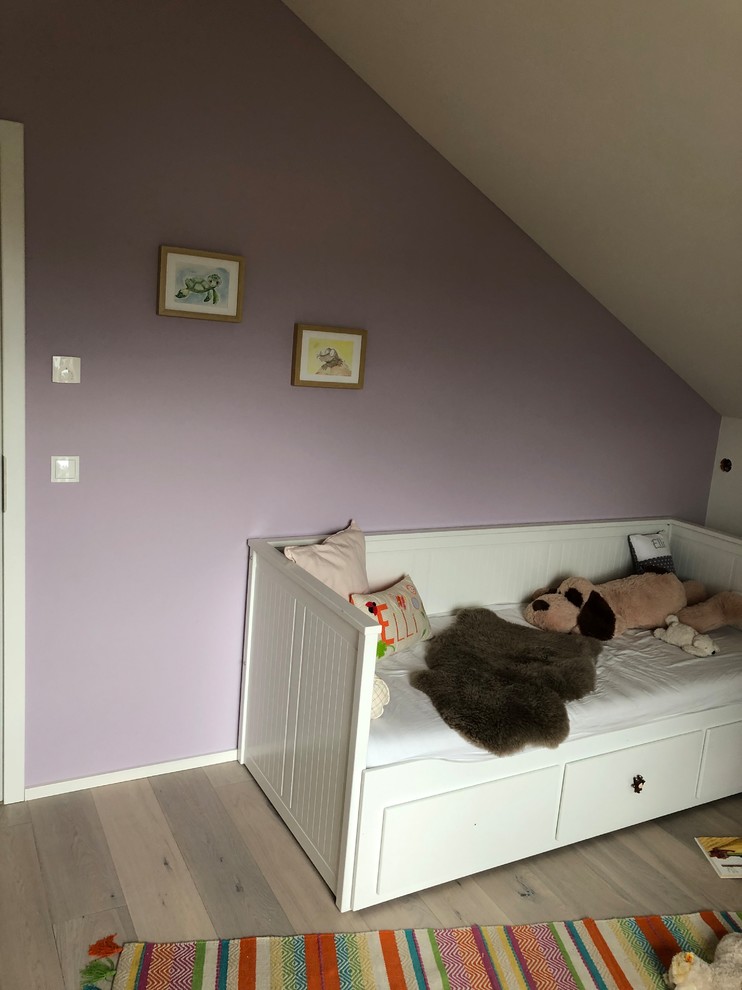 Mittelgroßes Landhaus Mädchenzimmer mit Schlafplatz, lila Wandfarbe, braunem Holzboden und braunem Boden in Köln