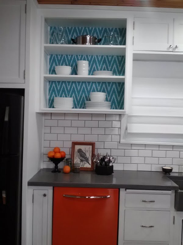 This is an example of a mid-sized country galley eat-in kitchen in Minneapolis with an integrated sink, open cabinets, white cabinets, concrete benchtops, white splashback, subway tile splashback, coloured appliances, cork floors and with island.