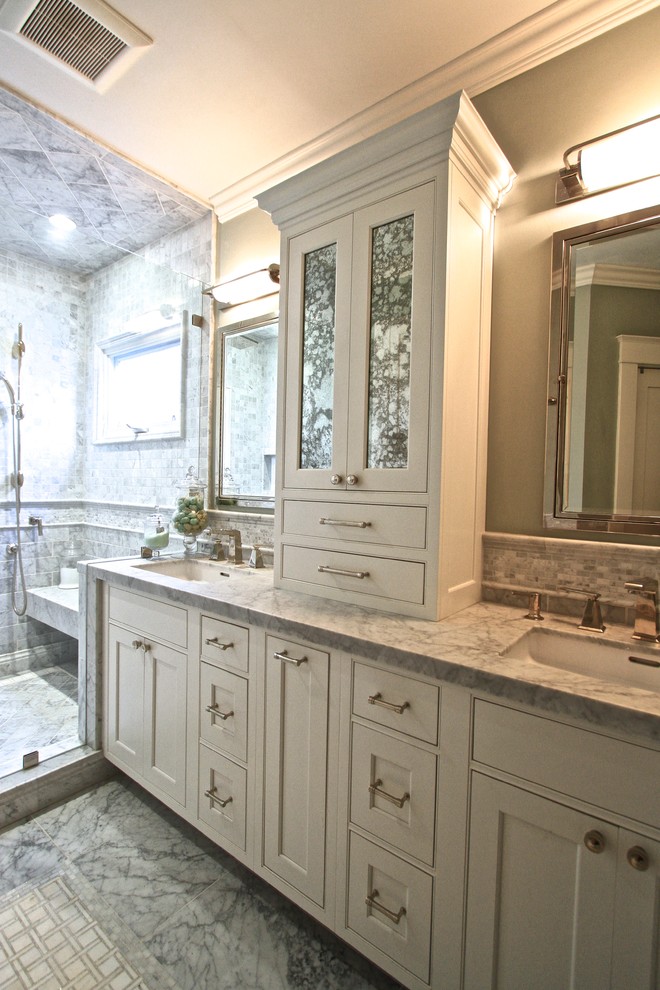 This is an example of an expansive transitional master bathroom in Orange County with shaker cabinets, beige cabinets, an alcove shower, a two-piece toilet, beige tile, green walls, marble floors, an undermount sink and marble benchtops.