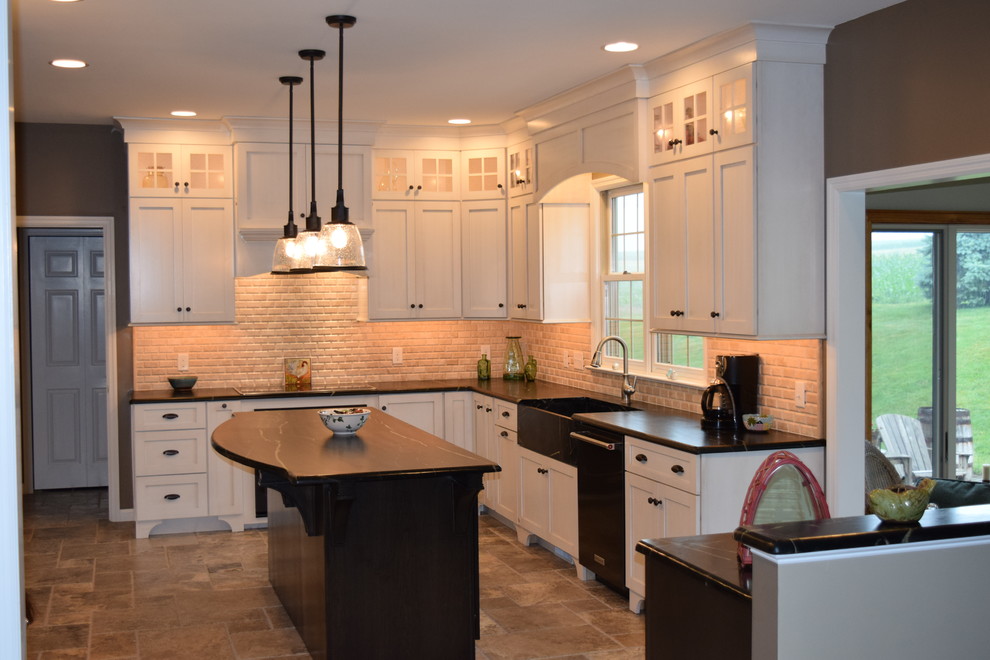 Kitchen - transitional l-shaped ceramic tile kitchen idea with an undermount sink, shaker cabinets, white cabinets, quartz countertops, beige backsplash, subway tile backsplash, black appliances and an island