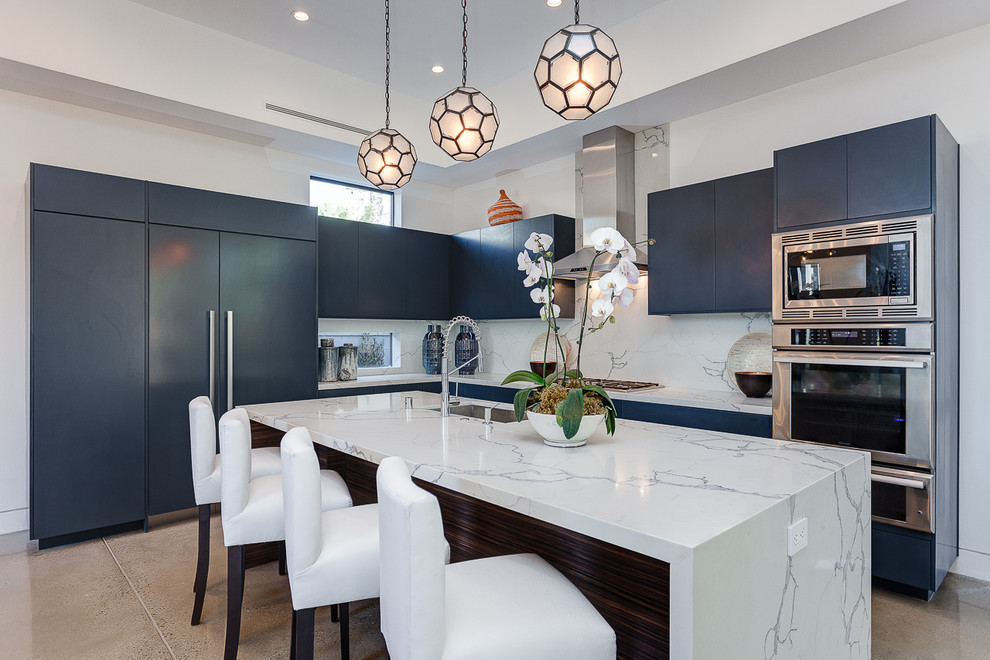 Inspiration for a contemporary l-shaped kitchen in San Francisco with an undermount sink, flat-panel cabinets, blue cabinets, white splashback, stone slab splashback, stainless steel appliances, with island and grey floor.