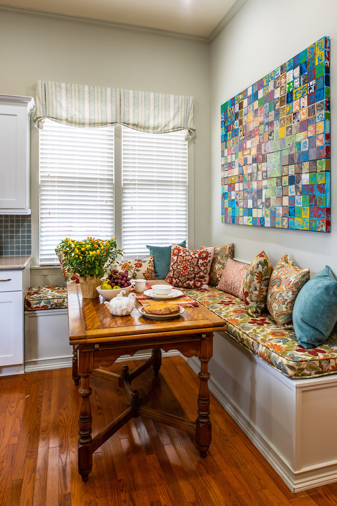 Photo of an eclectic eat-in kitchen in Austin with medium hardwood floors.