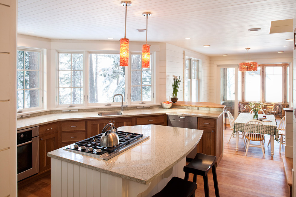 Design ideas for a traditional u-shaped eat-in kitchen in Portland Maine with recycled glass benchtops, an undermount sink, shaker cabinets, medium wood cabinets and stainless steel appliances.