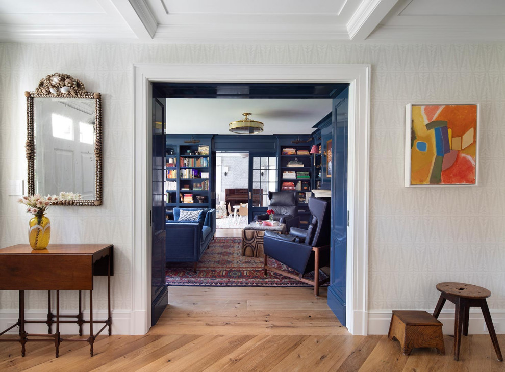 Comfortable and Collected - The family living in this shingled roofed home on the Peninsula loves color and pattern. At the heart of the two-story house, we created a library with high gloss lapis blue walls. The tête-à-tête provides an inviting place for the couple to read while their children play games at the antique card table. As a counterpoint, the open planned family, dining room, and kitchen have white walls. We selected a deep aubergine for the kitchen cabinetry. In the tranquil master suite, we layered celadon and sky blue while the daughters' room features pink, purple, and citrine.