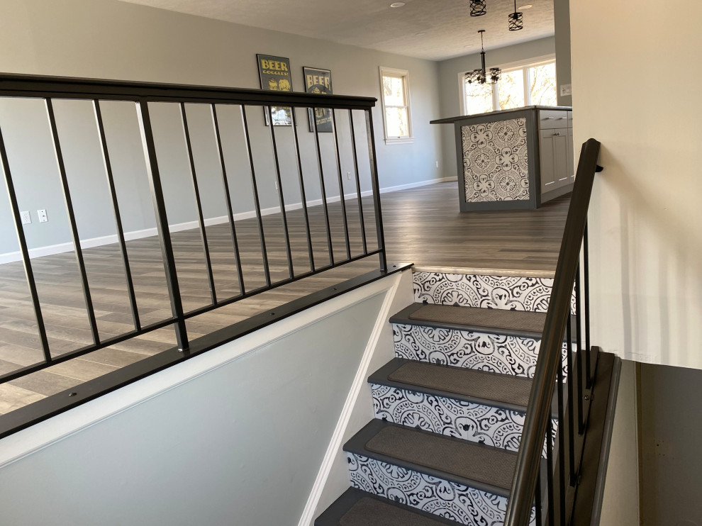 Example of a large transitional l-shaped vinyl floor and gray floor open concept kitchen design in Cincinnati with an undermount sink, raised-panel cabinets, white cabinets, granite countertops, multicolored backsplash, ceramic backsplash, stainless steel appliances, an island and black countertops