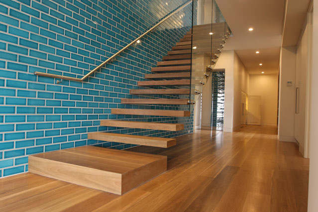 Inspiration for a modern wood straight staircase in Sydney with open risers.
