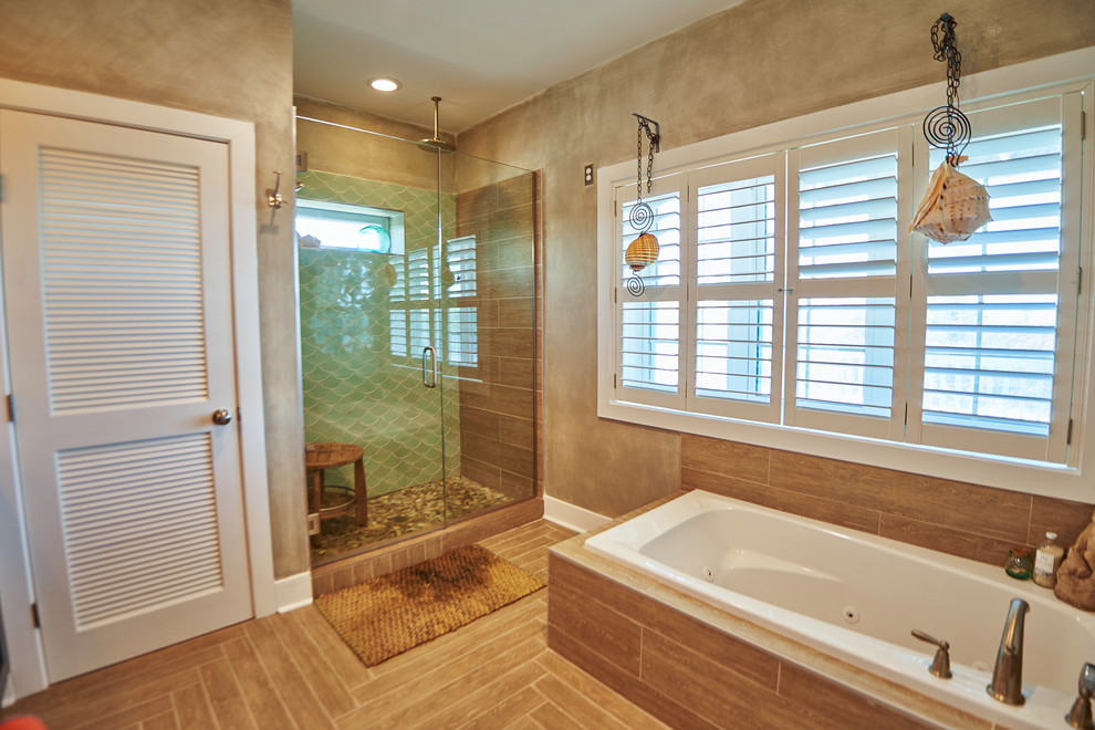 Design ideas for a large beach style master bathroom in Other with louvered cabinets, blue cabinets, a drop-in tub, an alcove shower, green tile, porcelain tile, beige walls, porcelain floors, an undermount sink, brown floor, a hinged shower door and white benchtops.