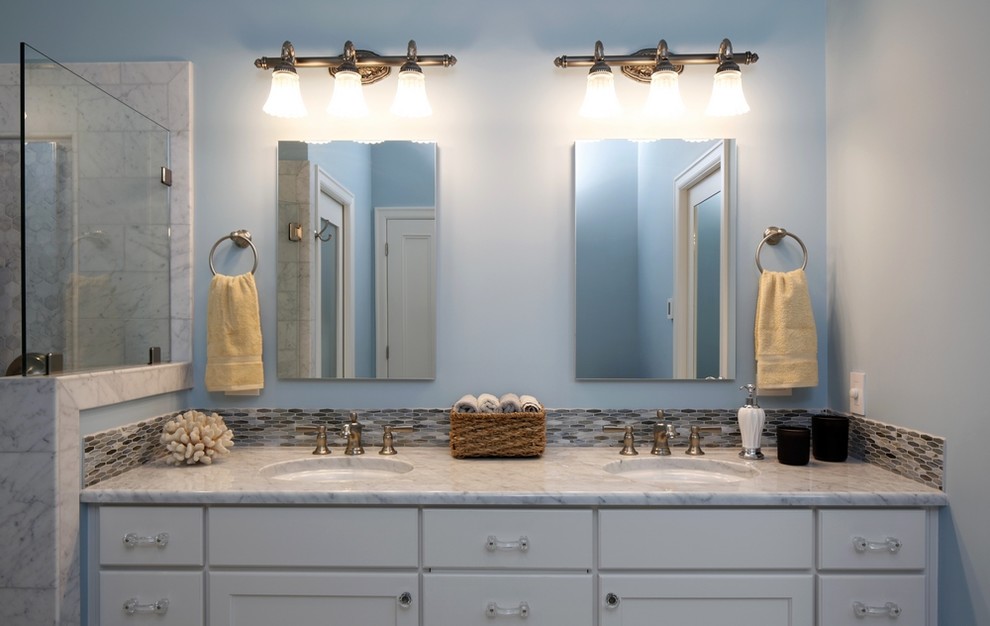 Large traditional master bathroom in Other with recessed-panel cabinets, white cabinets, a corner shower, a two-piece toilet, white tile, glass tile, blue walls, marble floors, an undermount sink and marble benchtops.