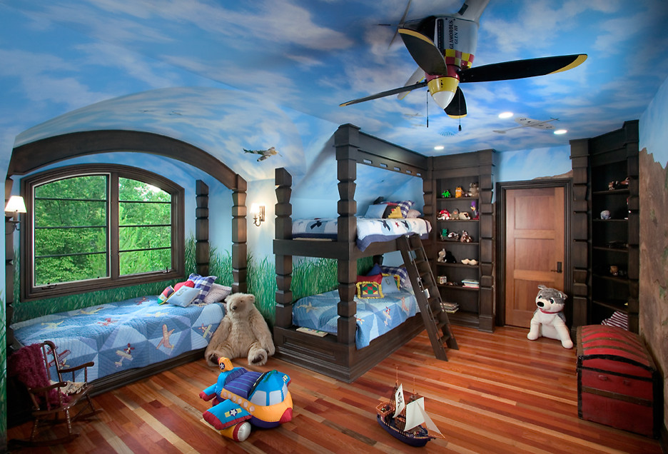 This is an example of an expansive traditional kids' bedroom for kids 4-10 years old and boys in Grand Rapids with blue walls and light hardwood floors.