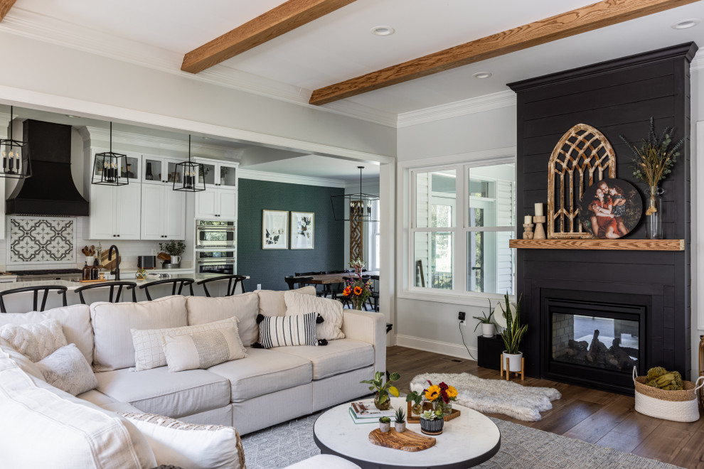 Design ideas for a mid-sized country open concept family room in DC Metro with white walls, vinyl floors, a two-sided fireplace, a wall-mounted tv, brown floor, exposed beam and wallpaper.