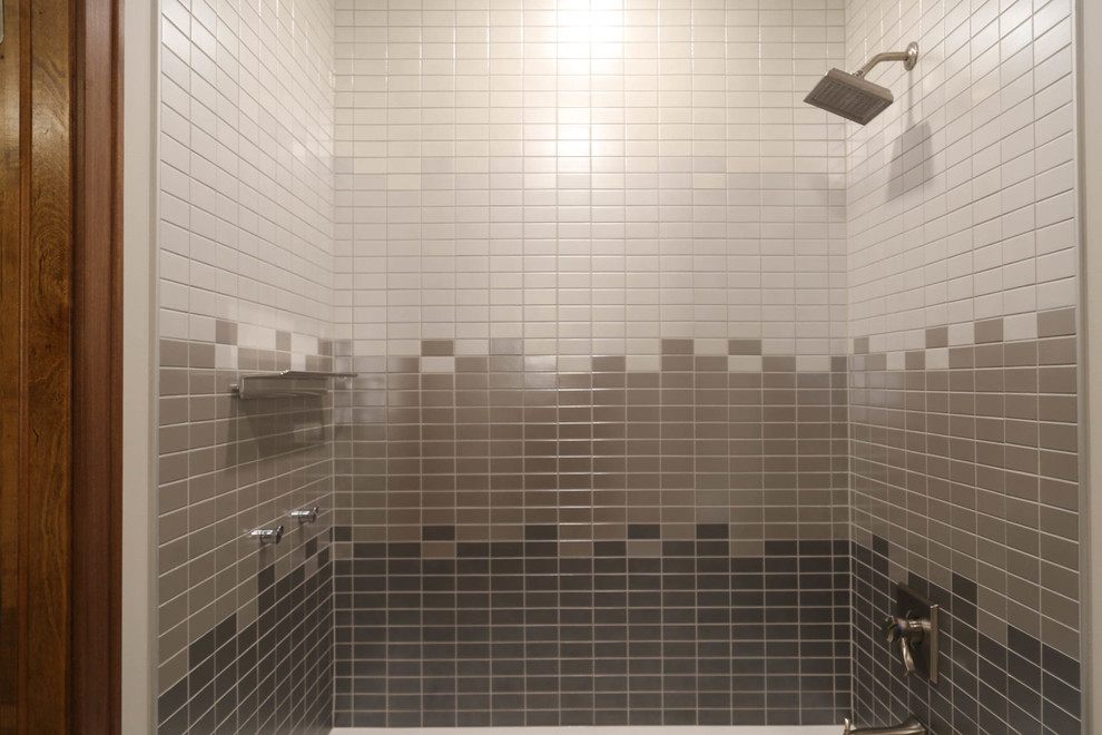 Example of a mid-sized transitional kids' gray tile and porcelain tile porcelain tile and white floor alcove bathtub design with recessed-panel cabinets, gray cabinets, a two-piece toilet, white walls, an undermount sink, quartzite countertops and white countertops