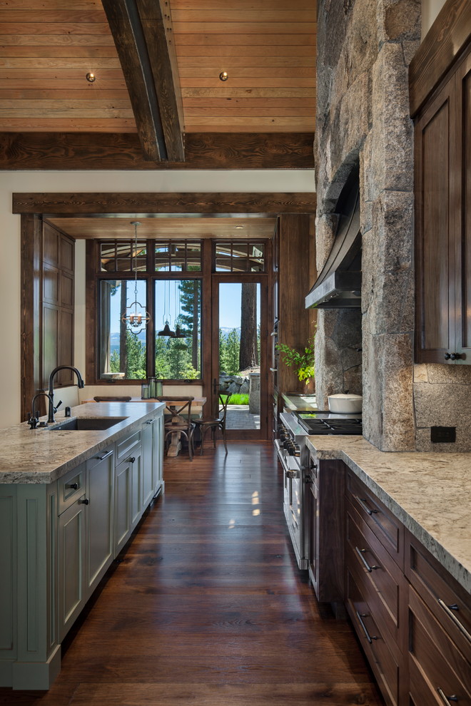 Design ideas for a large arts and crafts open plan kitchen in Sacramento with an undermount sink, shaker cabinets, dark wood cabinets, granite benchtops, grey splashback, stainless steel appliances, dark hardwood floors, multiple islands and brown floor.