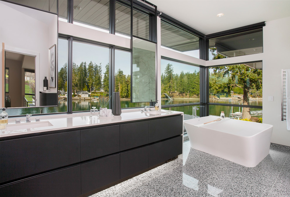 Inspiration for an expansive contemporary master bathroom in Seattle with flat-panel cabinets, black cabinets, a freestanding tub, white walls, terrazzo floors, an undermount sink, grey floor, white benchtops, a double vanity and a floating vanity.