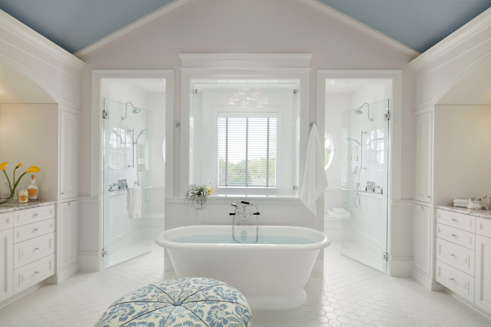 Freestanding bathtub - coastal white tile white floor freestanding bathtub idea in Denver with recessed-panel cabinets, white cabinets, gray walls and a hinged shower door