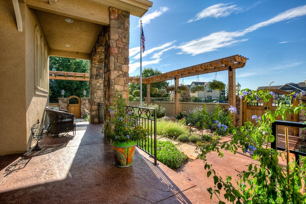 Inspiration for a mid-sized transitional partial sun front yard stone walkway in Denver.
