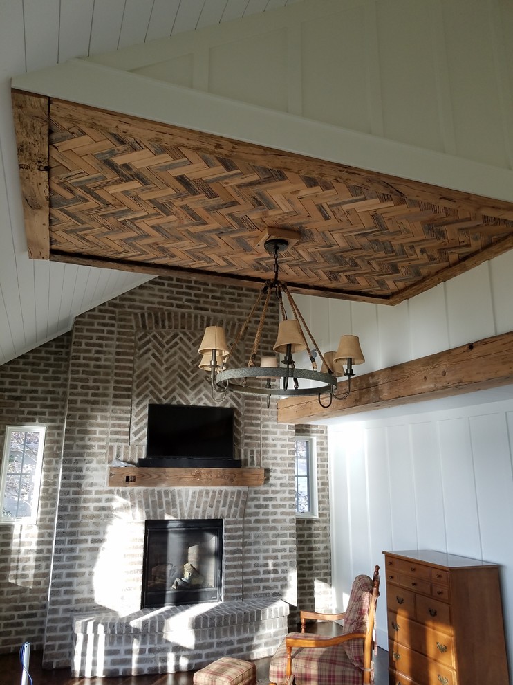 Inspiration for a country master bedroom in Milwaukee with a brick fireplace surround.