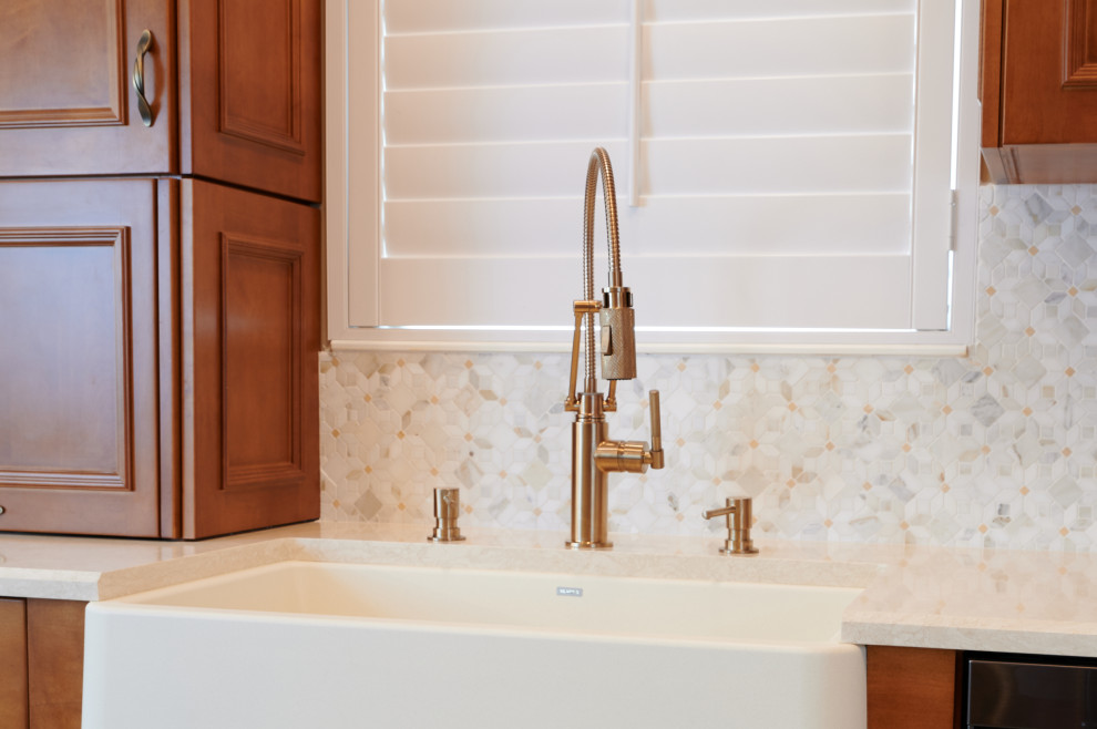 Kitchen - mid-sized transitional galley porcelain tile, beige floor and tray ceiling kitchen idea with a farmhouse sink, recessed-panel cabinets, medium tone wood cabinets, quartz countertops, multicolored backsplash, marble backsplash, stainless steel appliances, a peninsula and beige countertops