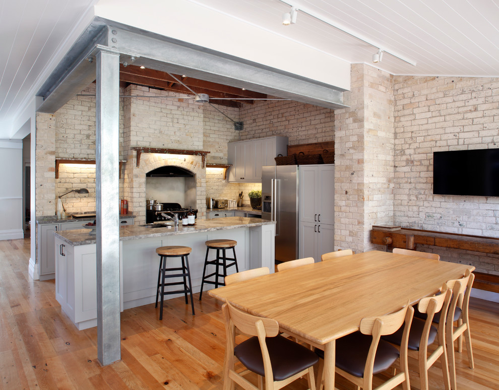 This is an example of an industrial kitchen/dining combo in Sydney.