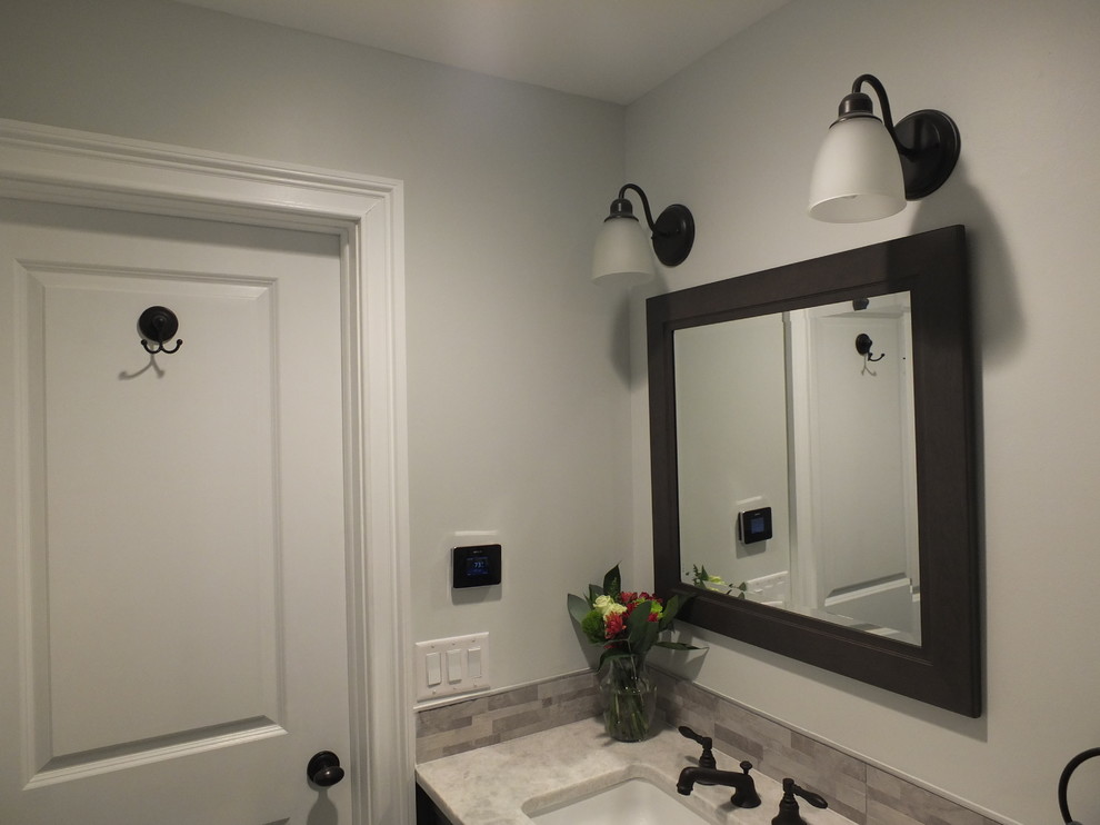 Photo of a small transitional 3/4 bathroom in New York with an undermount sink, quartzite benchtops, an alcove shower, a two-piece toilet, gray tile, porcelain tile and green walls.