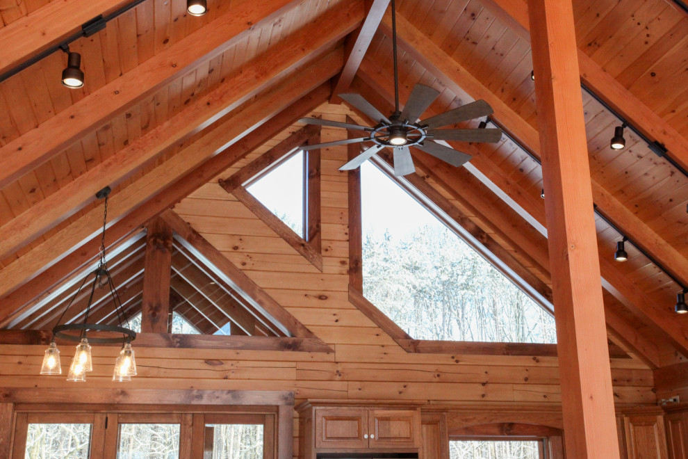 Inspiration for a rustic u-shaped light wood floor, yellow floor and wood ceiling eat-in kitchen remodel with a double-bowl sink, raised-panel cabinets, medium tone wood cabinets, wood backsplash, stainless steel appliances, an island and white countertops
