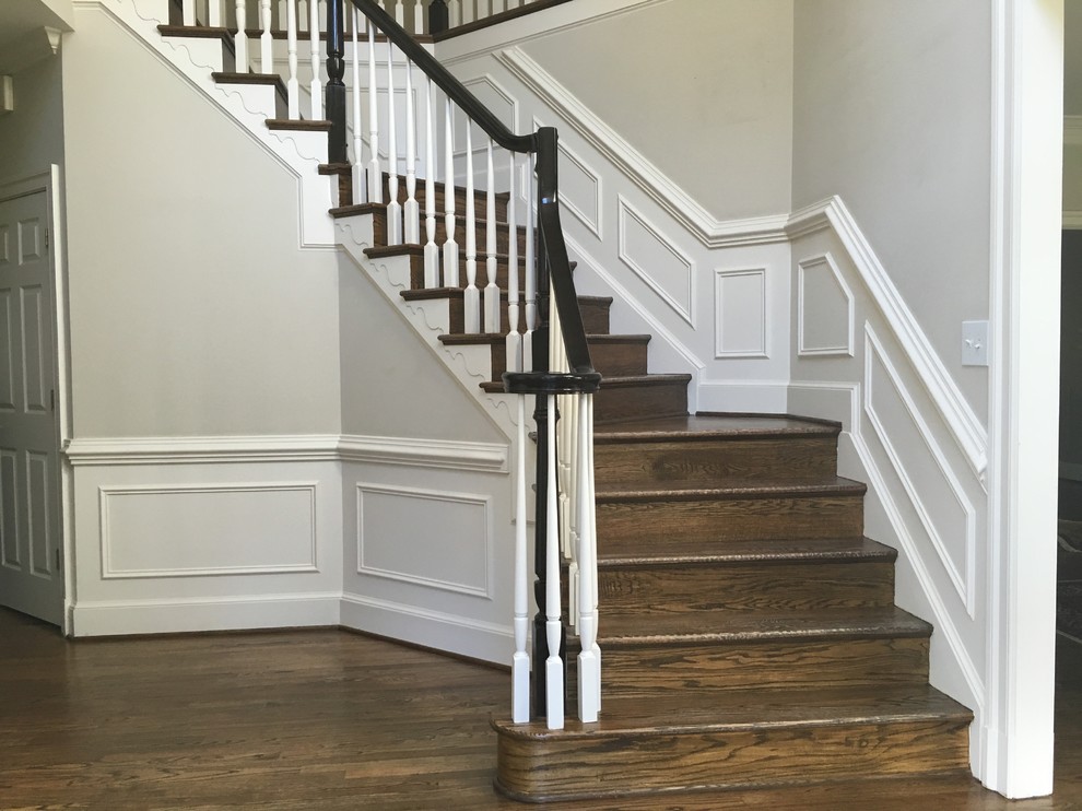 Inspiration for a large transitional wooden curved wood railing staircase remodel in DC Metro with wooden risers