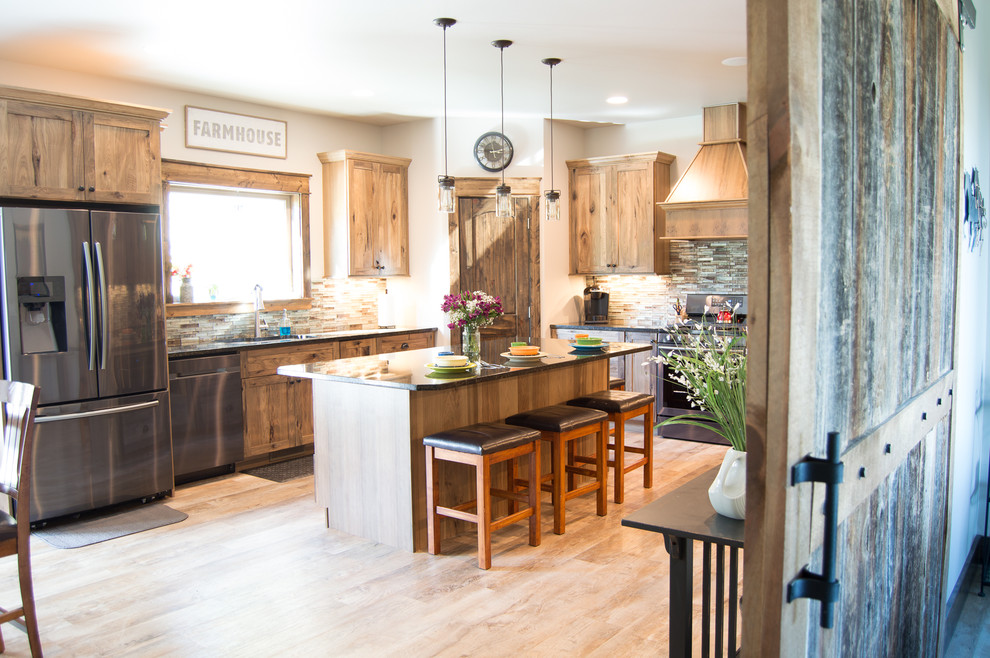 Eat-in kitchen - rustic u-shaped beige floor eat-in kitchen idea with shaker cabinets, brown cabinets, granite countertops, brown backsplash, stainless steel appliances, an island and gray countertops