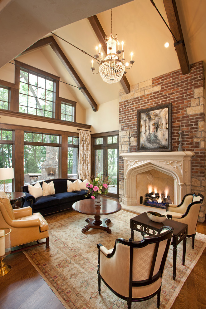 This is an example of a traditional living room in Minneapolis with dark hardwood floors and a standard fireplace.
