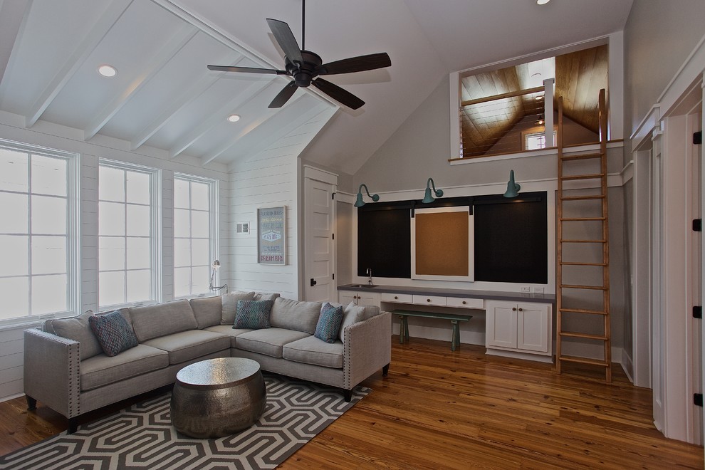 Inspiration for a beach style kids' room in Charleston with white walls and medium hardwood floors.