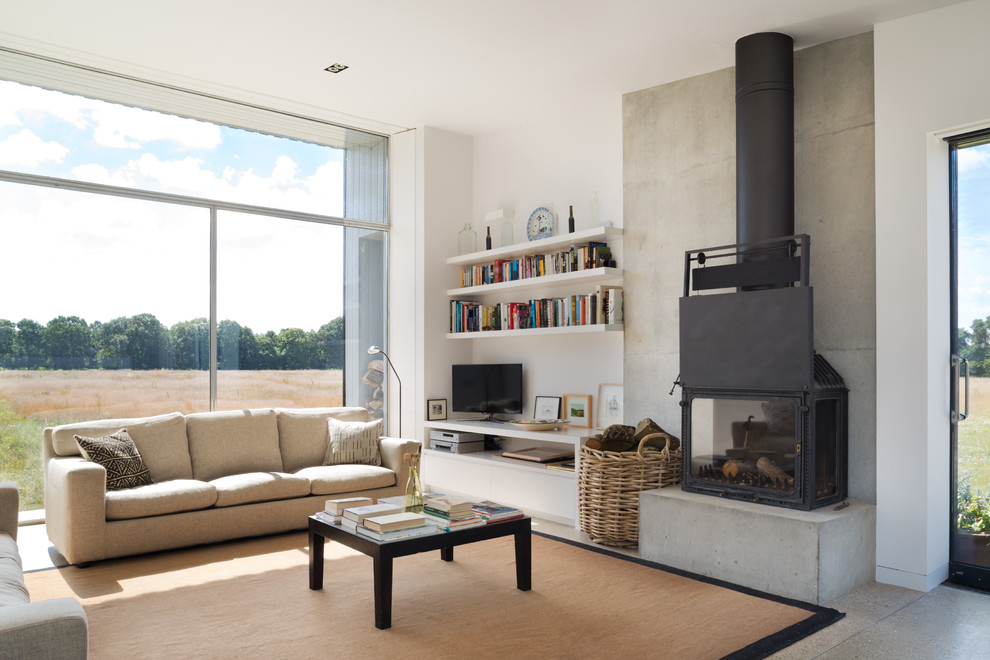 Photo of a mid-sized contemporary open concept living room in London with white walls and a wood stove.